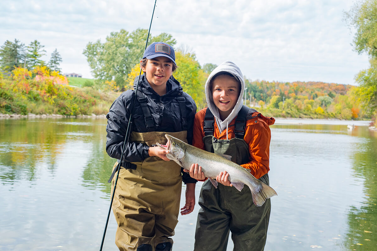 Children holding rainbow trout