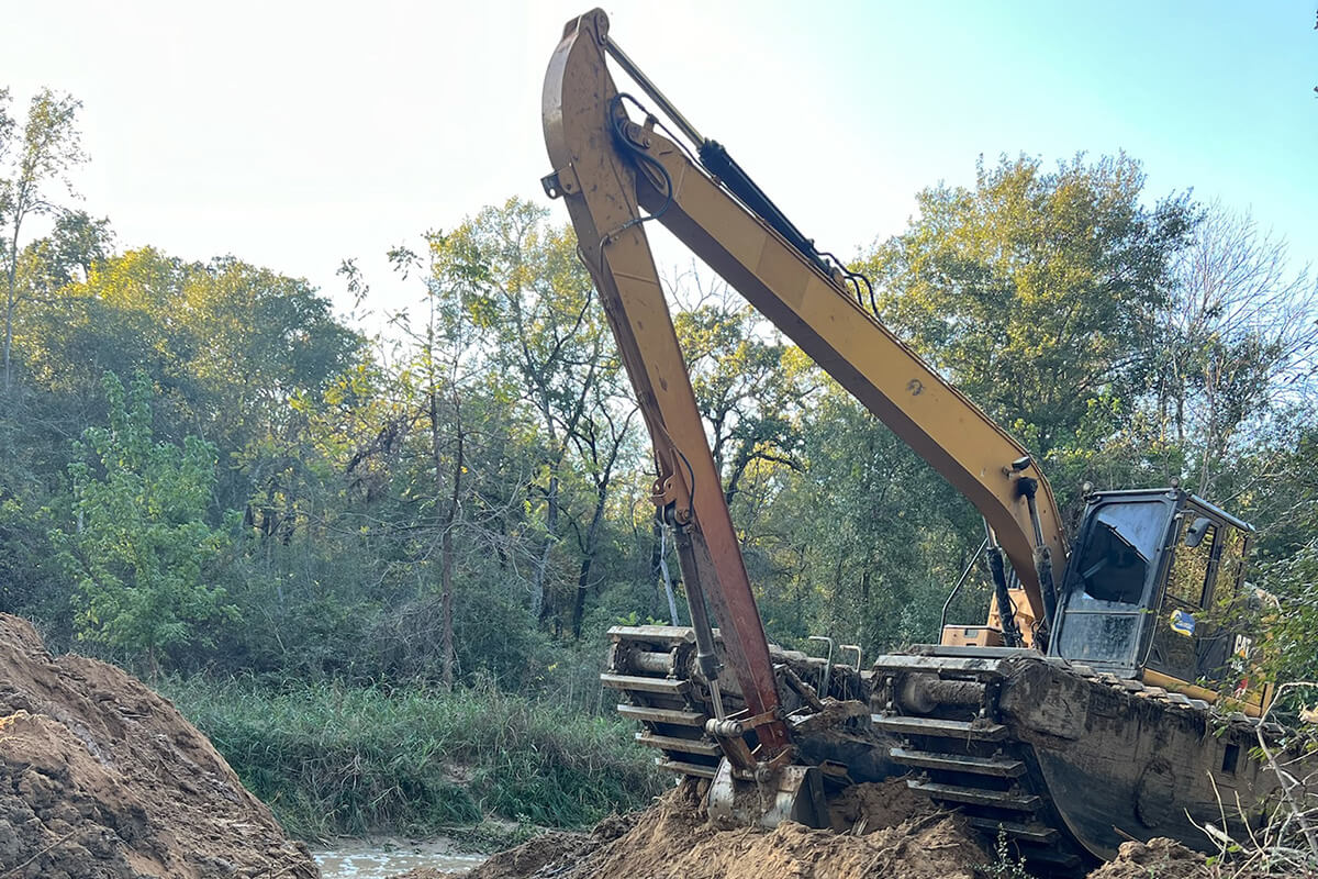 Excavator performing restoration
