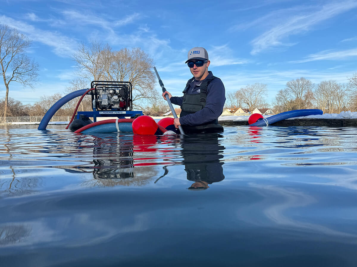 Man performing hydraulic dredging