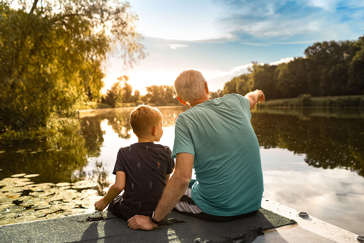 Man and child overlooking lake